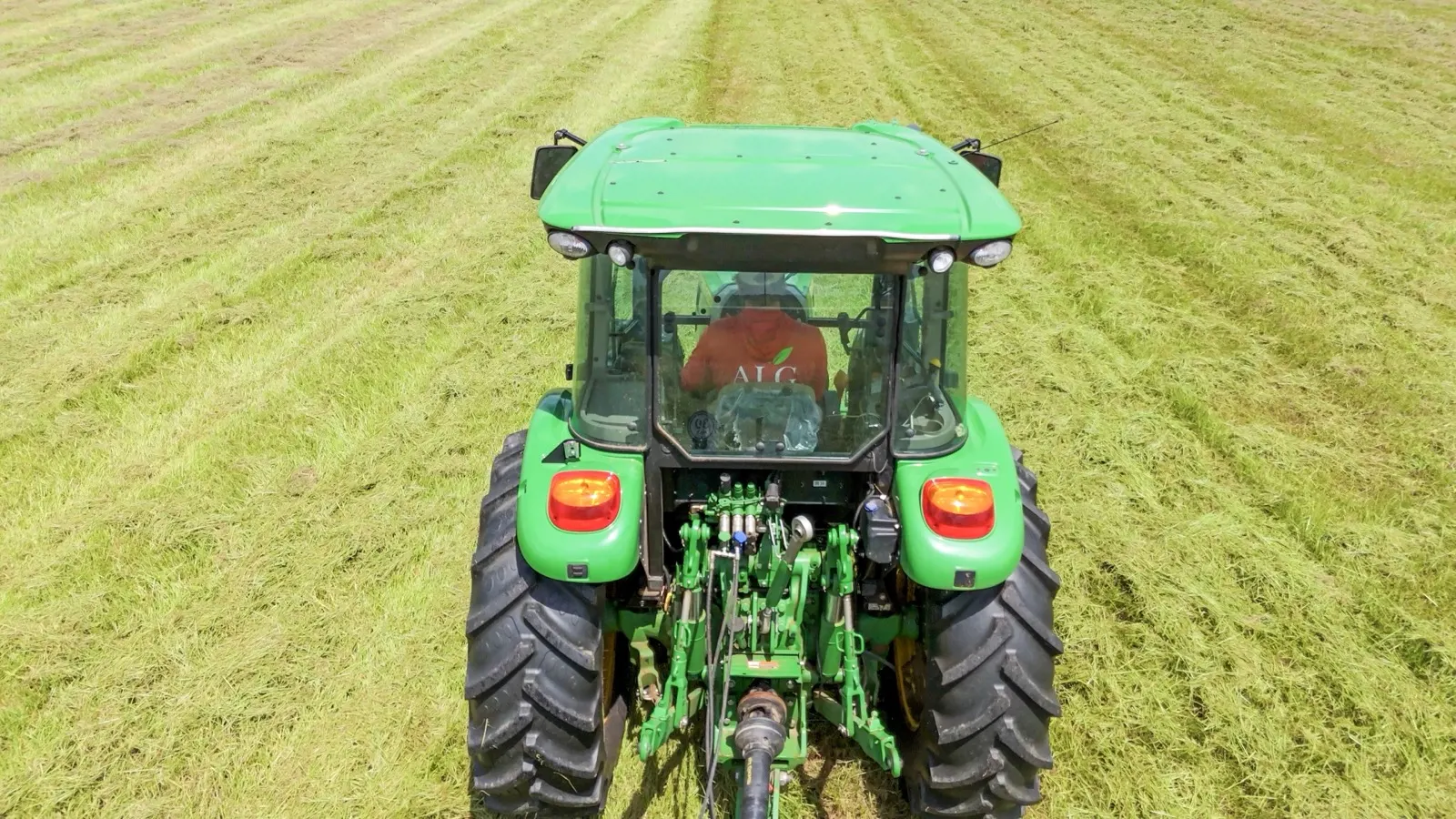Andrews Lawn & Garden operator in the tractor cab, cutting a field in Baldwin County, Alabama, seen from above