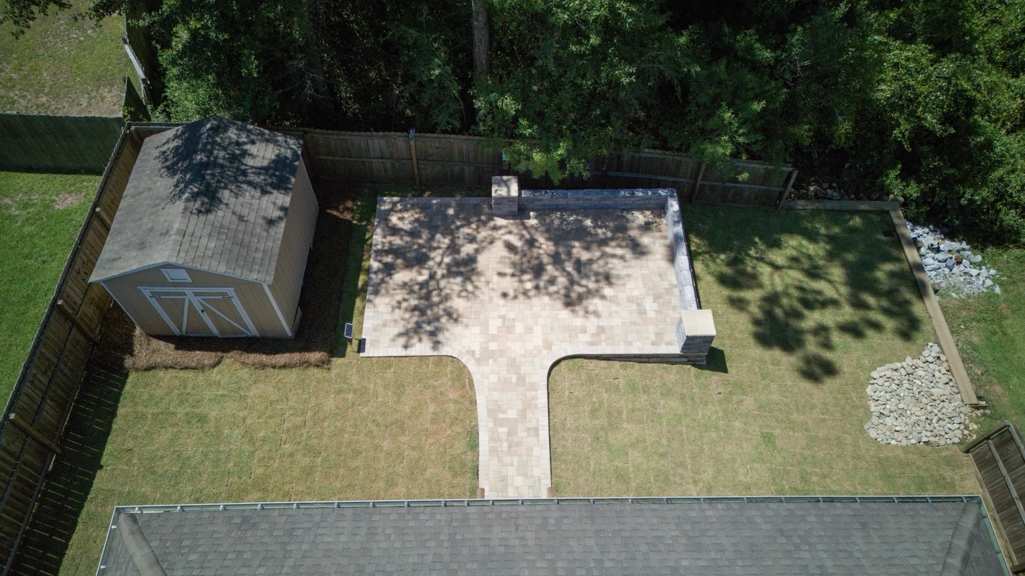 Aerial view of a finished paver patio and backyard in Baldwin County, Alabama