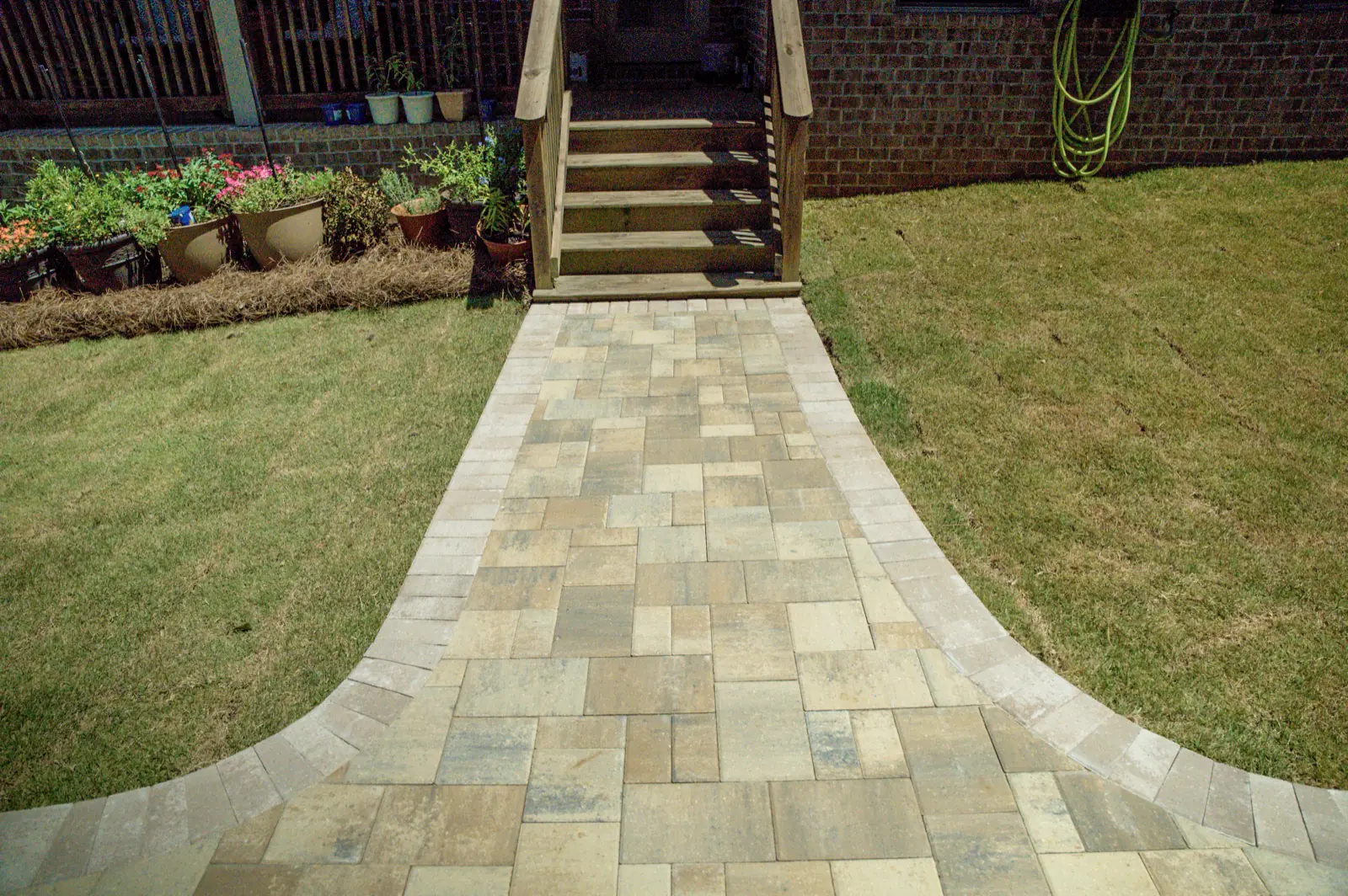 Paver walkway leading through a backyard in Baldwin County, Alabama