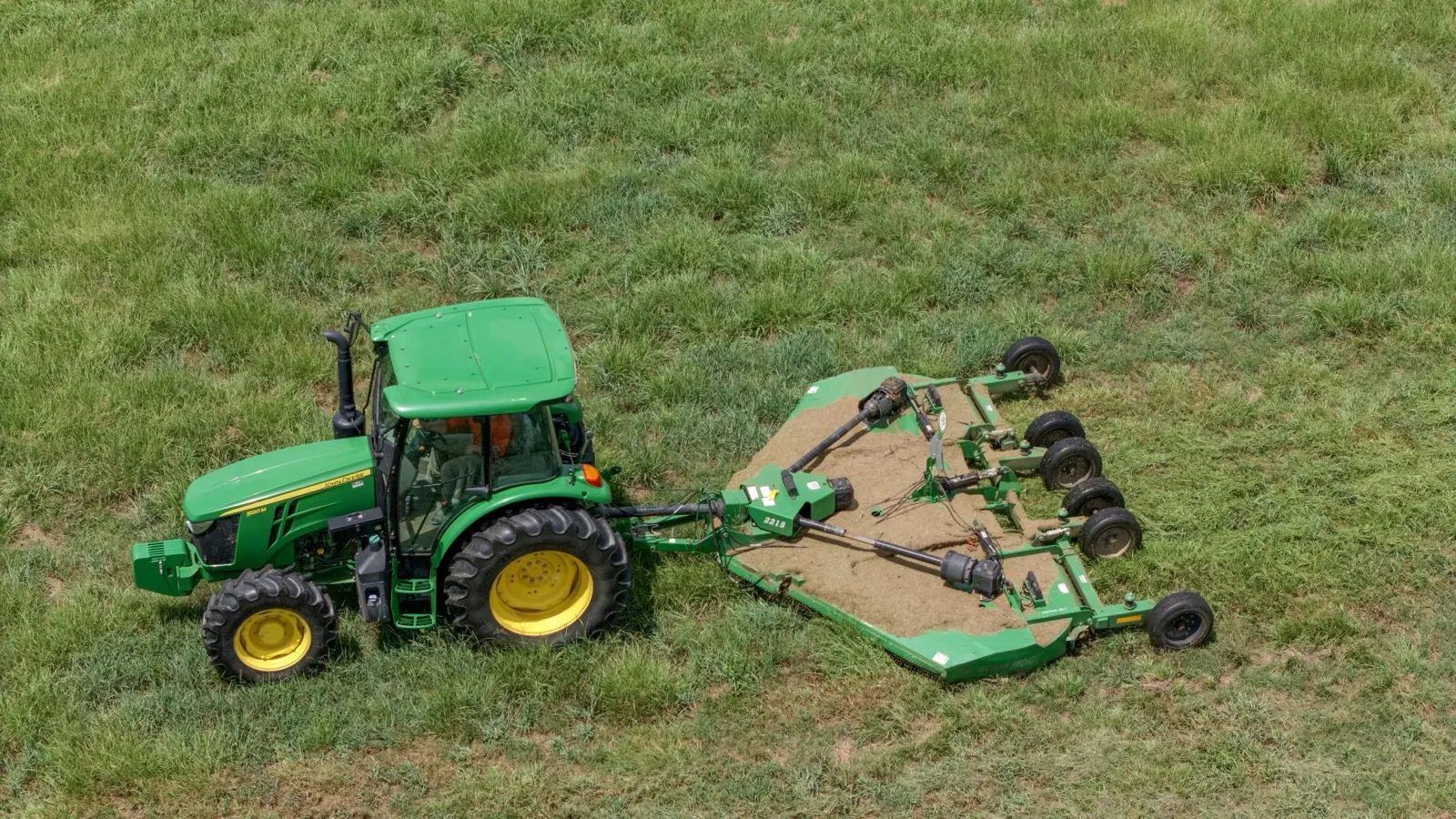 Batwing mower cutting campus grounds in Loxley, Alabama