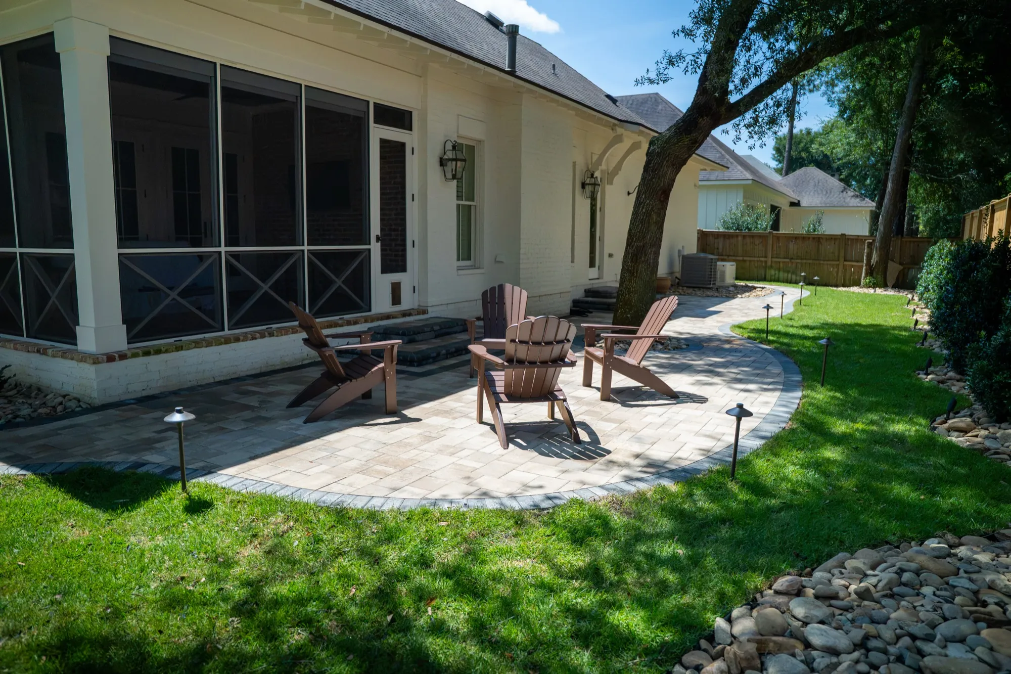 New paver patio beside a screened porch in Point Clear, Alabama